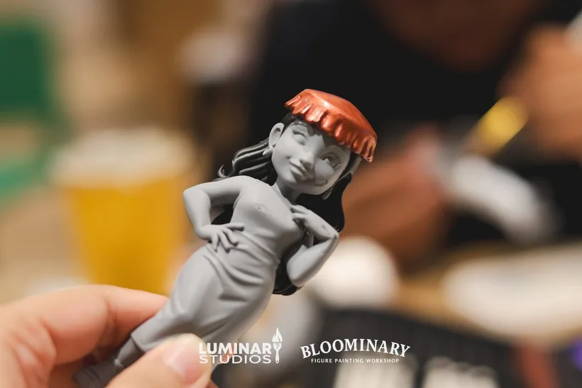 Close-up of a figure in progress with a red beret