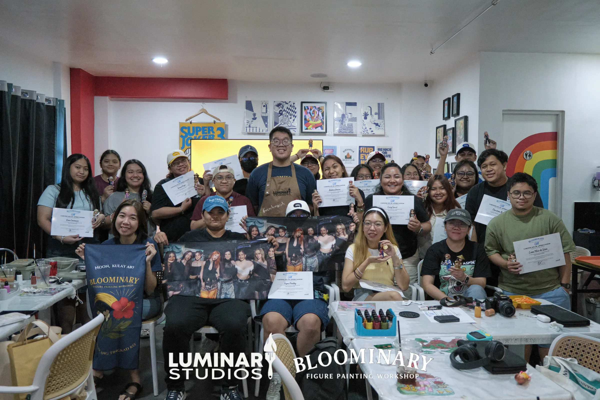 Bloominary OT8 workshop group holding painted figures and certificates