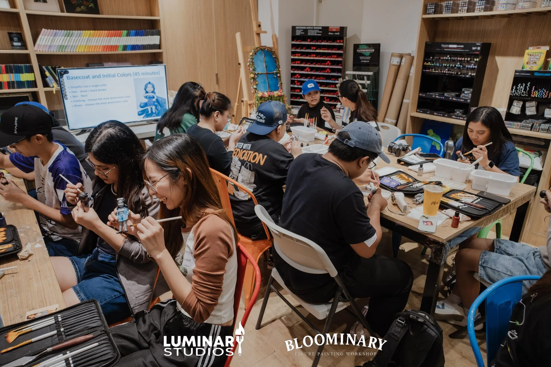Students painting at workshop tables